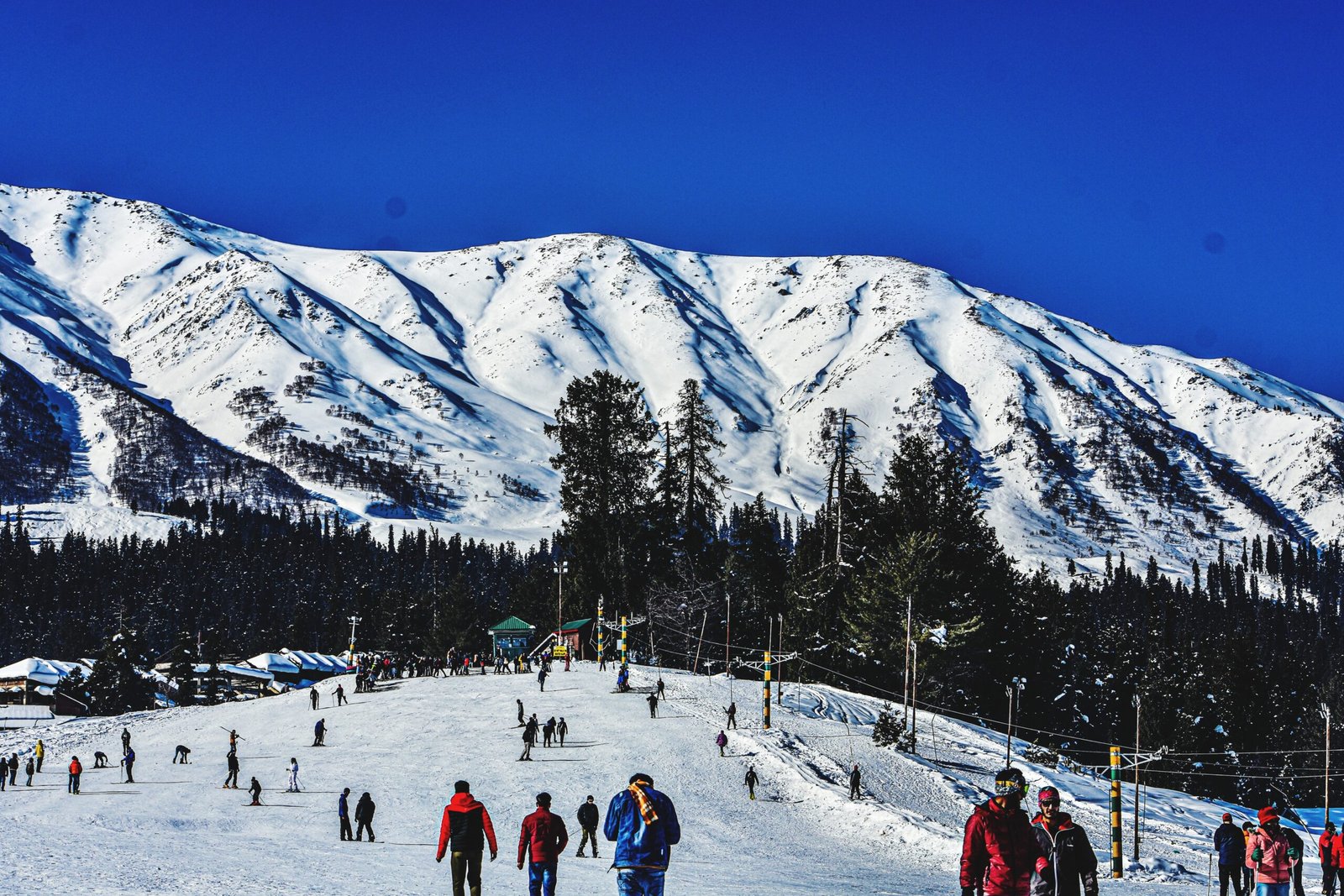 group people snowcapped mountain against sky scaled